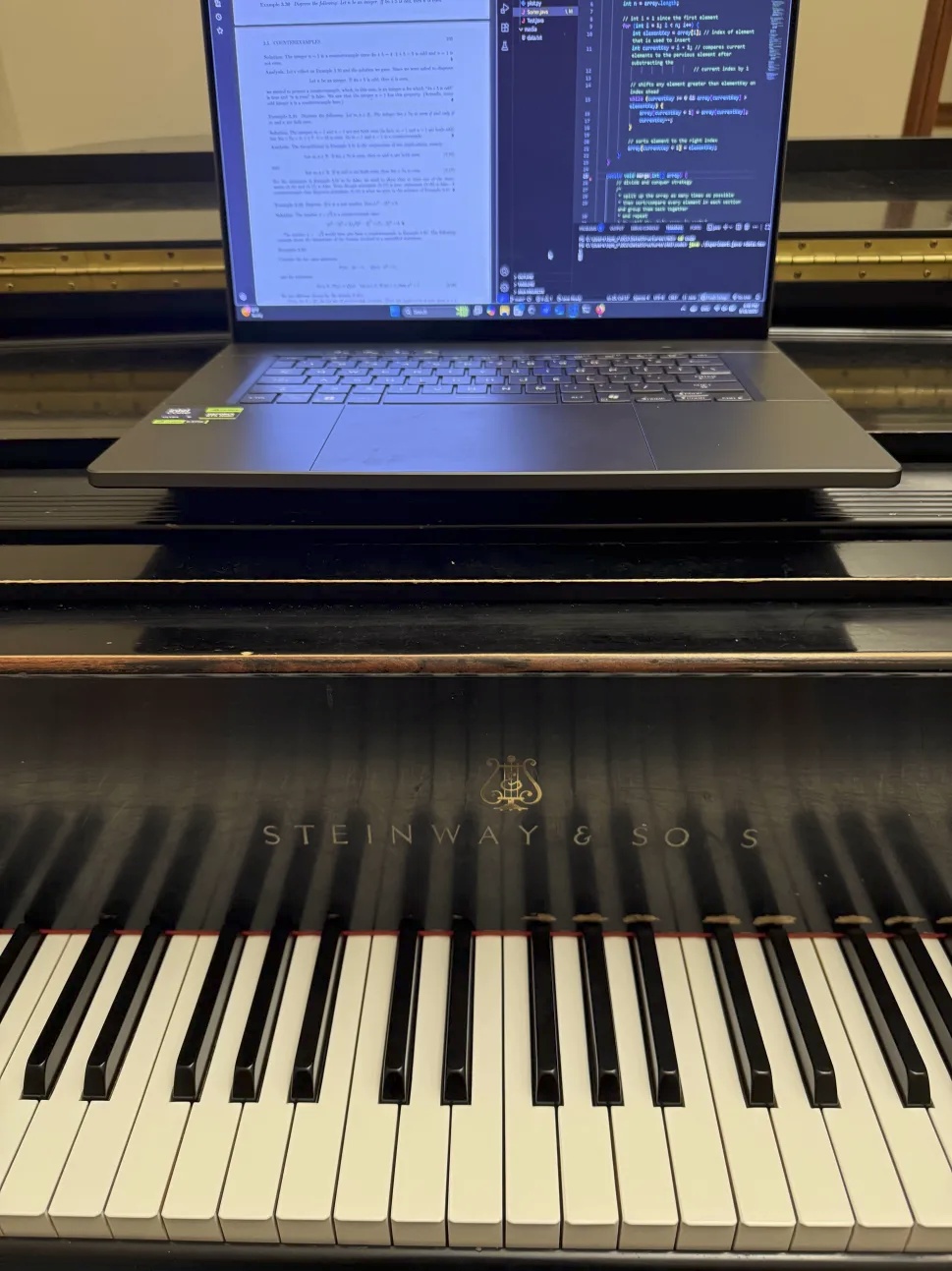 laptop ontop of piano